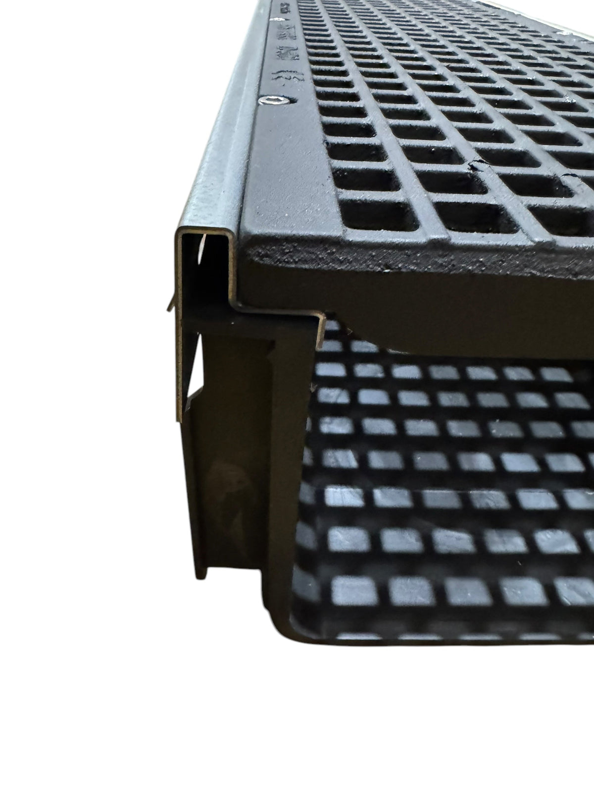 Close-up of a metal grating with a grid pattern on a white background