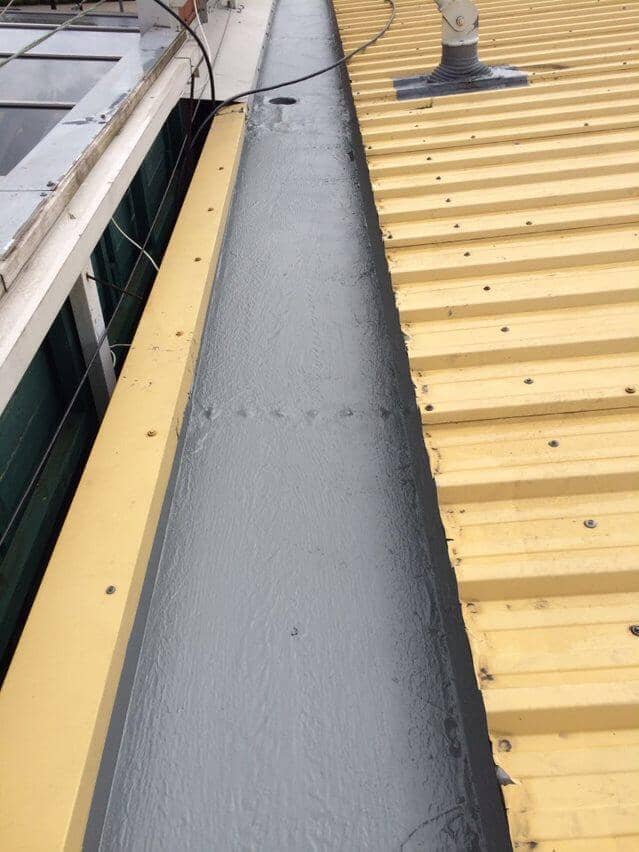 RapidRoof Waterproofing Kit applied on a large flat roof surface showing uniform waterproof finish.