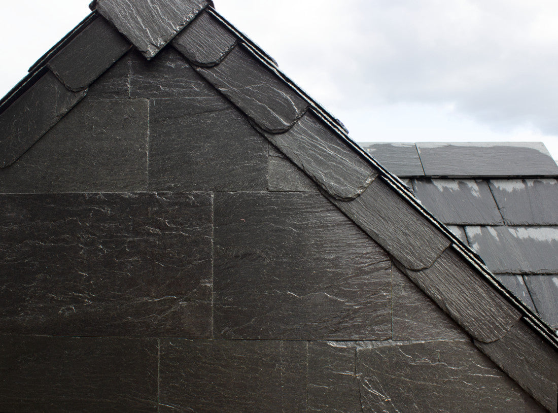 Close-up of a roof with dark gray slate tiles