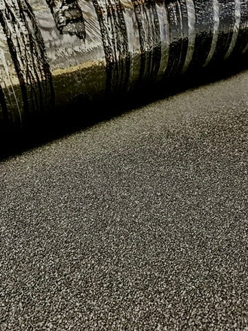 StrataBit Rapid-O torch-on bituminous membrane partially unrolled close-up showing mineral finish and edge detail