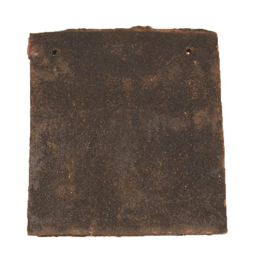 Close-up of a Tudor handmade clay gable tile showing its profile and texture
