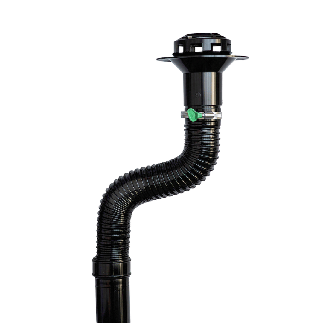 A black flexible corrugated drain pipe with a matching black pop-up drain assembly and a small green valve, shown on a plain white background.
