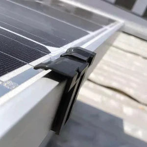 Solar panel with a black clip on a metal surface