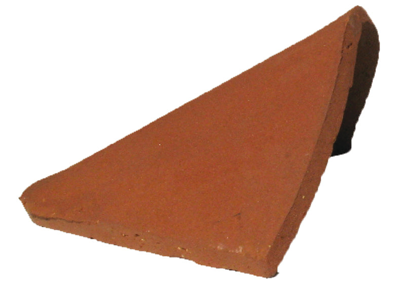 Side view of handmade clay bonnet hip tile showing curved profile for roof hips