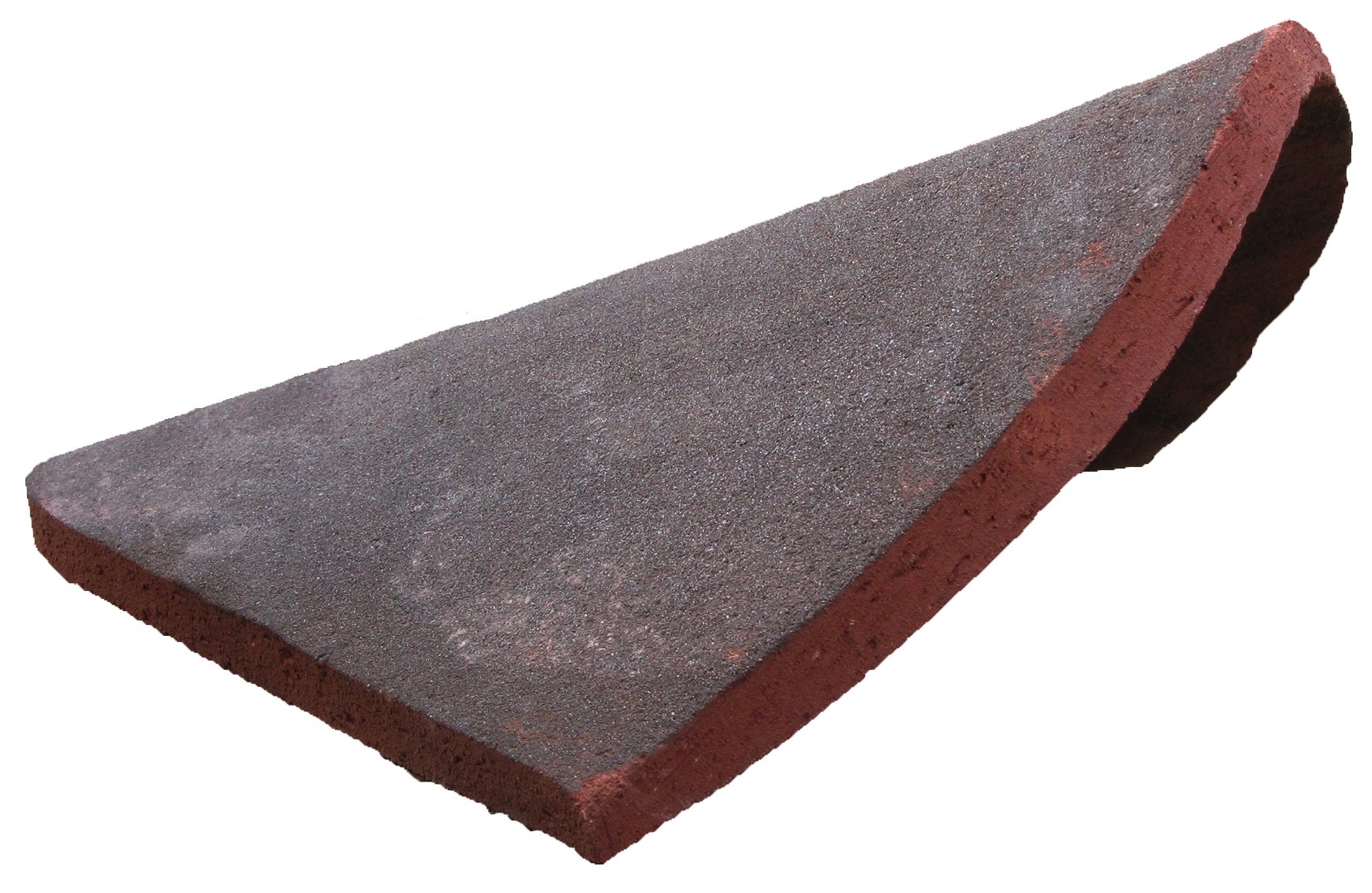 Side view of curved handmade clay eyebrow hip tile for roof hips