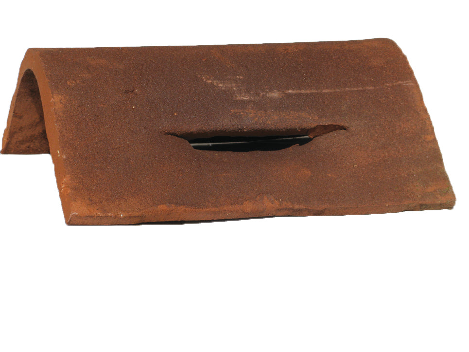 Handmade clay hogs back ridge tile with built-in vents for discreet roof ventilation

