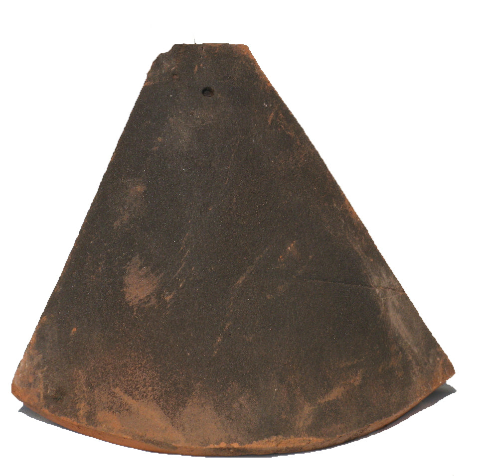 Top view of Sussex roof hip tile showing wide curved shape in traditional clay finish