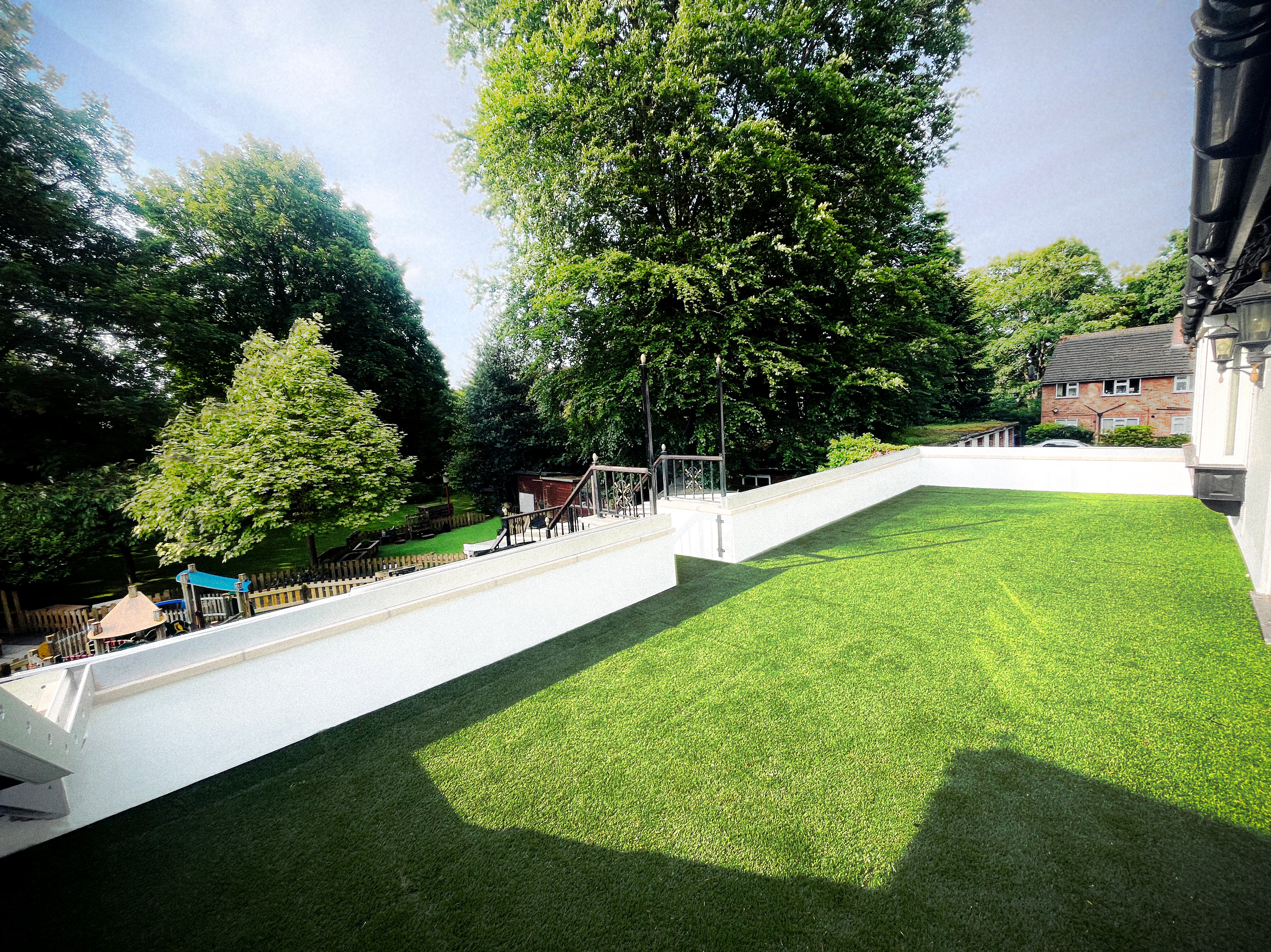 Outdoor area finished with Rubbertech ecotred Turf artificial lawn tiles creating a seamless green surface